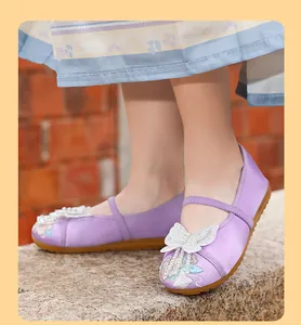 Detail view of purple embroidered Hanfu shoes for girls with elegant butterfly bow and pearls.