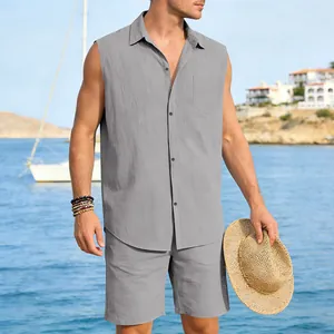 Full view of grey men's linen sleeveless shirt and shorts set in a beach setting