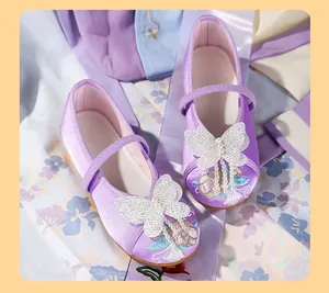 Detailed view of purple girl's Hanfu embroidered shoes with glittery butterfly tassels