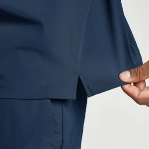 Detailed view of the hem of a navy blue quick-dry athletic jacket with side slit