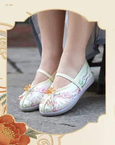 Close-up of traditional Chinese children's Hanfu shoes with pink floral embroidery