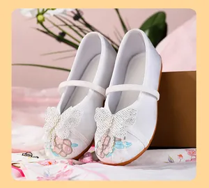 Detailed view of white traditional Chinese embroidered Hanfu shoes for girls with butterfly