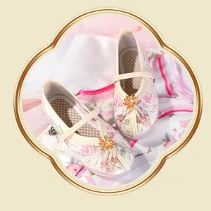 Close-up of elegant handmade Hanfu embroidered shoes for girls with floral patterns