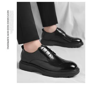 Detail view of elegant men's black crocodile embossed lace-up business dress shoes