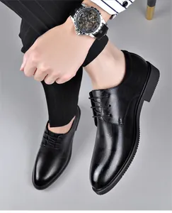 Men's formal black leather lace-up business shoes with stylish texture on a model