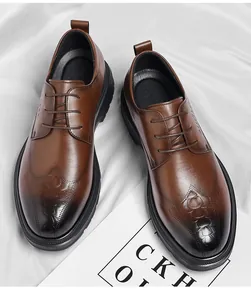 Detail view of brown crocodile-embossed men's dress shoes with a gradient finish