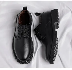 Gros plan de chaussures en cuir noir pour hommes avec doublure chaude sur tissu blanc.