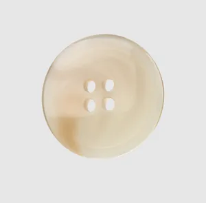 Close-up detail of a premium cream-colored resin button with four holes and texture