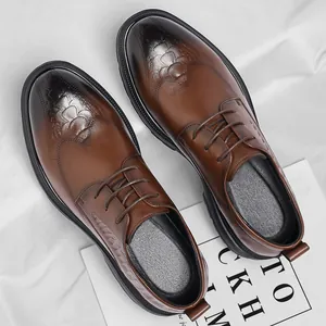 Classic brown leather wingtip dress shoes for men's formal business wear with brogue details