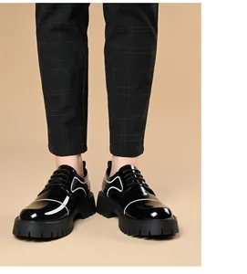 Detailed close-up of men's shiny black platform shoes with stylish white wavy accents