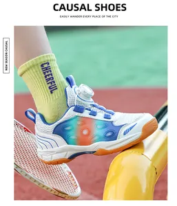 Breathable kids badminton shoe with orange gradient and rotary dial lace system.