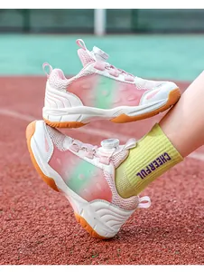 Close-up detail of breathable youth badminton shoes with pink and green gradient finish