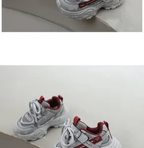 Close-up view of grey and red breathable mesh sneakers for children with soft soles.
