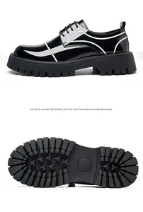 Side view of glossy black leather men's shoes with detailed rugged lug sole texture