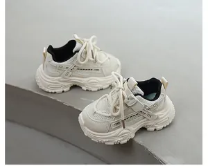 Detailed close-up of breathable cream children's sneakers with chunky soft soles and laces