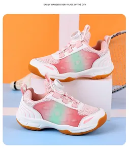 Pink and green gradient youth badminton shoes displayed with shuttlecock