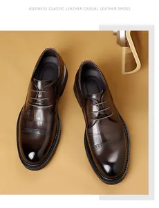 Detail view of brown men's formal brogue leather shoes with embossed pattern.