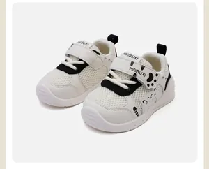 Detailed view of breathable white toddler walking shoes with a cute cartoon cat design