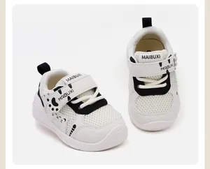 Close-up of white cartoon baby walking shoes with breathable mesh and soft anti-slip sole