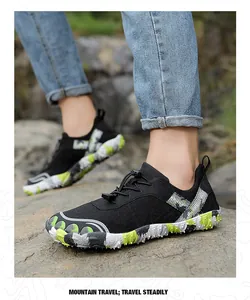 Close-up of outdoor hiking shoes with anti-slip soles on a rocky mountain path