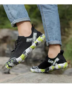 Detailed side view of black outdoor hiking shoes featuring durable camouflage non-slip soles