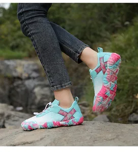 Lightweight outdoor hiking and water shoes worn on a rock in a natural landscape setting