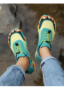 Detailed view of teal and yellow non-slip outdoor hiking shoes during an outdoor trek
