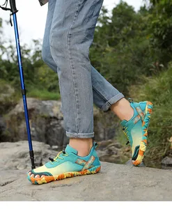 Outdoor hiking shoes shown in a rugged natural trail setting with trekking pole.