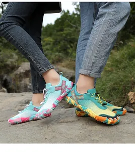 Close-up view of colorful non-slip outdoor hiking toe shoes on a rocky forest path