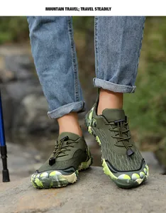 Detailed macro view of durable green non-slip outdoor hiking shoes on a rocky mountain path.