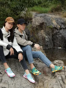 Anti-slip outdoor hiking shoes for men and women in vibrant colors shown in nature