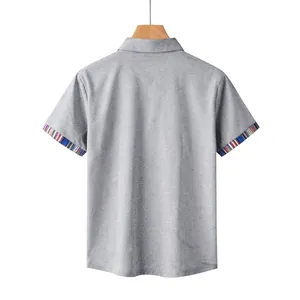 Back view of a grey short-sleeve polo shirt featuring colorful Navajo striped cuffs