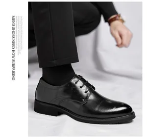Detailed view of men's elegant black leather dress shoes with grid pattern texture
