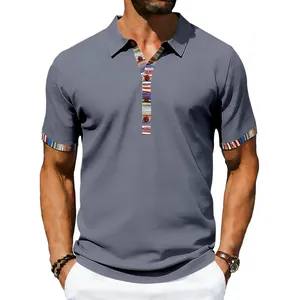 Close-up of men's grey polo shirt with colorful Navajo patterned collar and cuffs