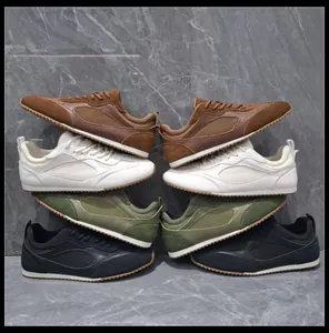 Multiple colors of retro casual sneakers stacked symmetrically on grey marble wall