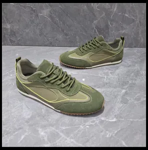 Detailed close-up of olive green retro German trainer sneakers with soft rubber soles