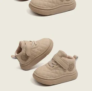 Close-up of beige quilted toddler high-top walking shoes with star logo detail