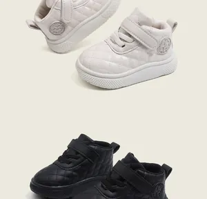 Detailed view of quilted high-top toddler shoes in off-white and black color options
