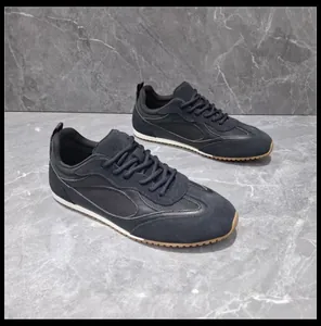 Detail of retro black German Army Trainers sneakers with soft sole and mesh panels.