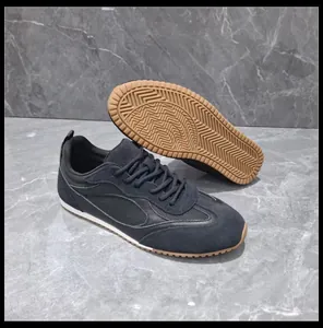 Detailed view of black retro sneakers with gum rubber traction sole and mesh panels