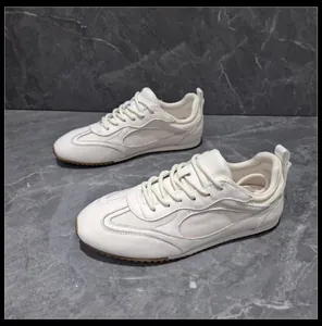Detailed side view of white retro German Army Trainers featuring soft gum soles and leather.