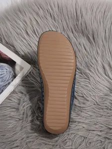 Close-up detail of the anti-slip brown rubber sole for women's wedge winter slippers