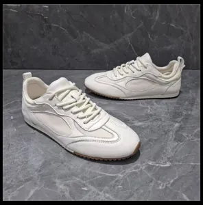 Detailed view of white retro German Army Trainer sneakers with mesh panels and gum sole