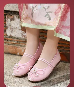 Close-up of pink breathable mesh Hanfu shoes with floral embroidery and beads.