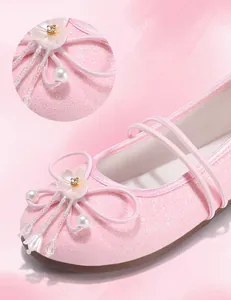 Detail shot of pink Hanfu girl shoes featuring pearl flower ornaments and glittery finish