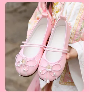 Detail of pink Hanfu embroidered shoes with floral pearl bow and breathable mesh fabric.