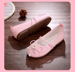 Detailed macro view of pink glitter girls' Hanfu flats featuring floral pearl bow
