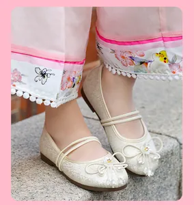 Close-up of girls' breathable mesh Hanfu shoes with pearl bow details in white
