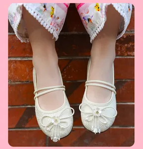 Close-up of breathable mesh Hanfu flats featuring elegant floral bow and pearl details