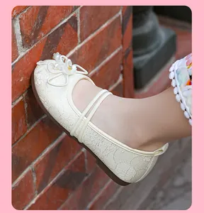 Close-up of cream breathable mesh Hanfu flat shoe with pearl flower ornament detail